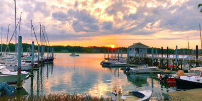 sunset overlooking boats at the dock